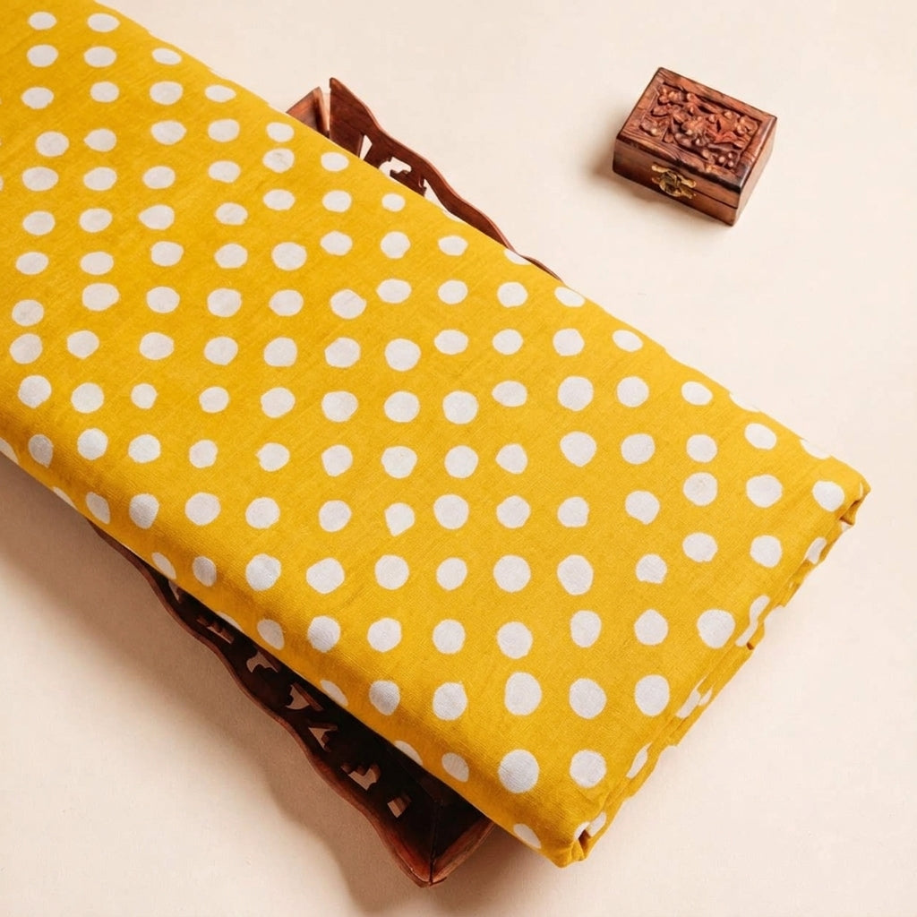 Folded Yellow Polka Dots Cotton Fabric Highlighting Polka Dots and Texture