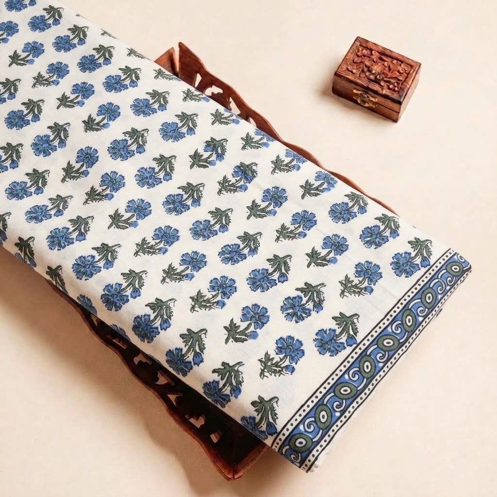 Folded White Floral Cotton Fabric Highlighting Border and Texture
