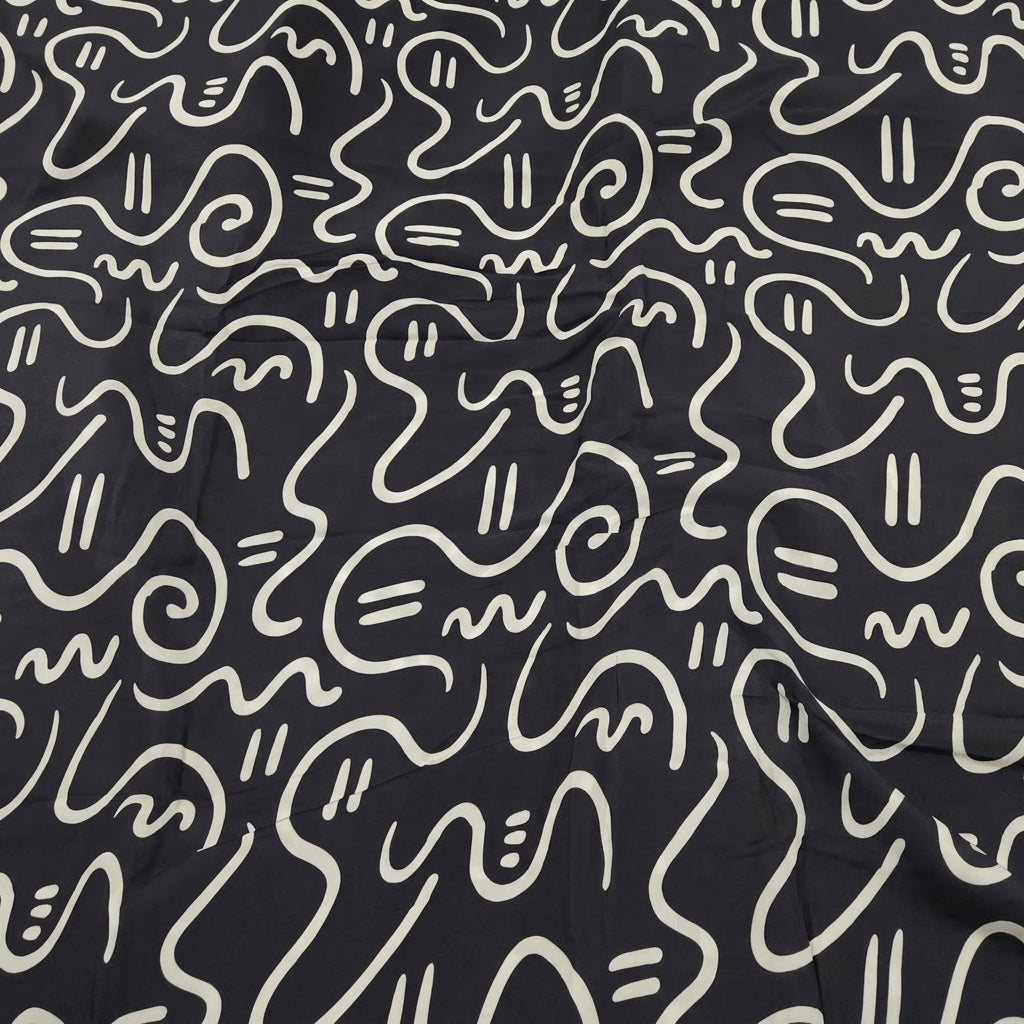 Swirled Black Abstract Crepe Fabric Showing Drape