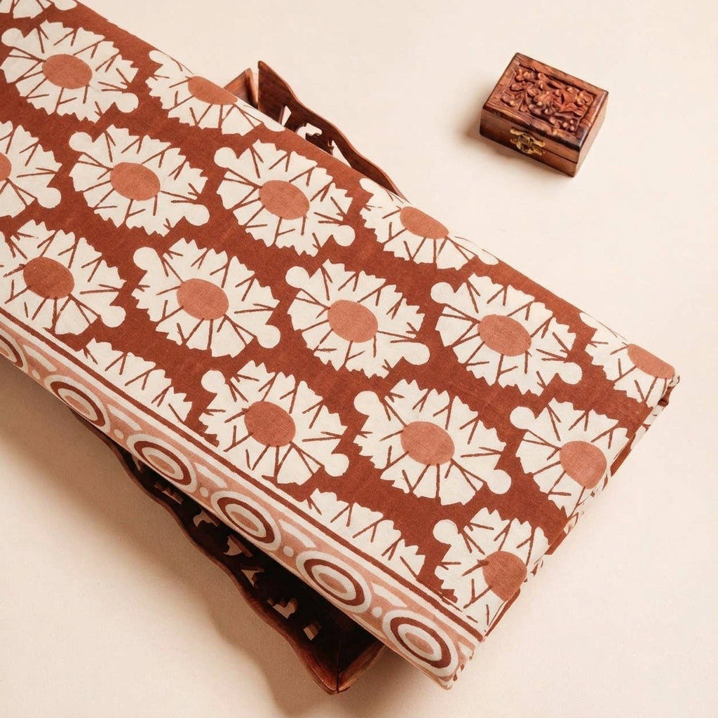 Folded Orange Floral Cotton Fabric Highlighting Border and Texture
