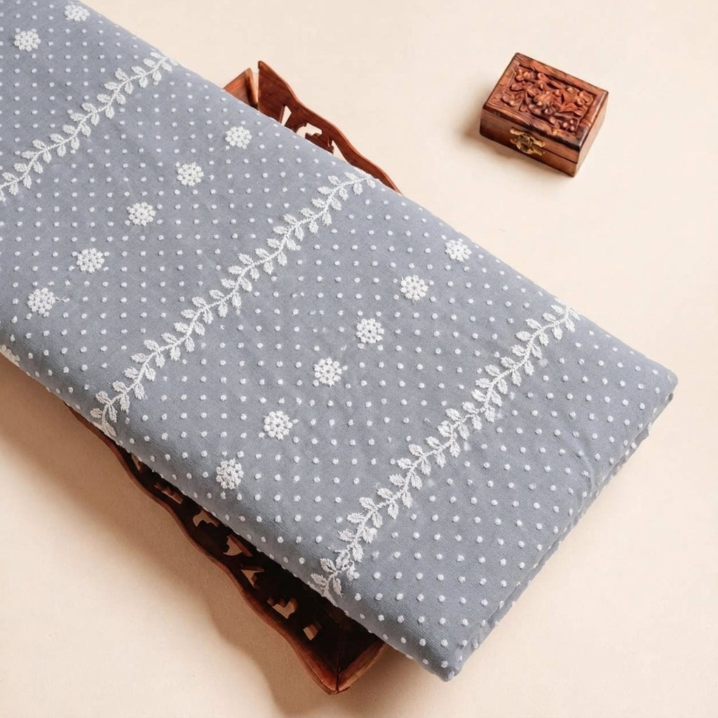 Folded Grey Embroidery Cotton Fabric Highlighting Thread Work and Texture