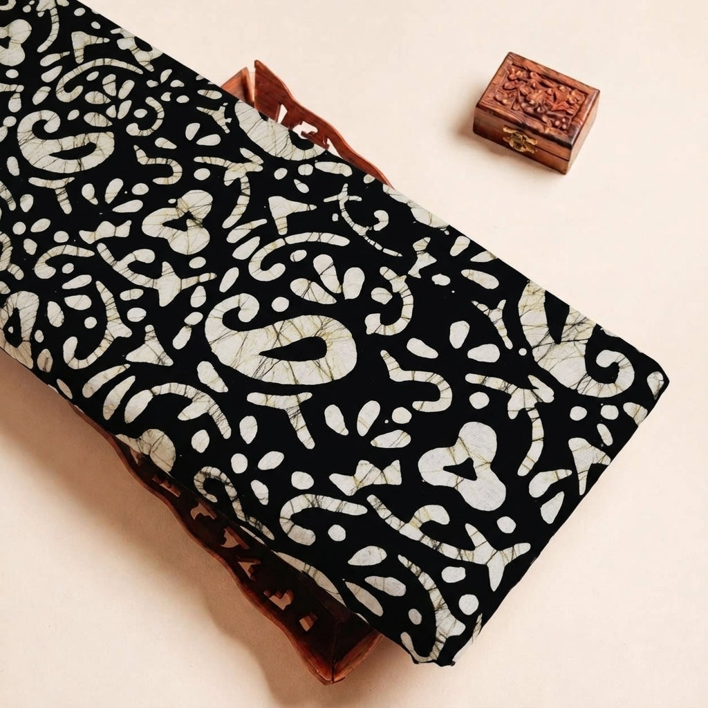 Folded Black Batik Cotton Fabric Highlighting Paisley and Texture