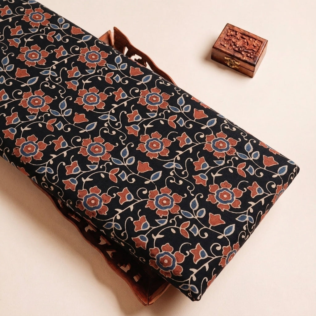 Folded Black Ajrakh Cotton Fabric Highlighting Floral and Texture