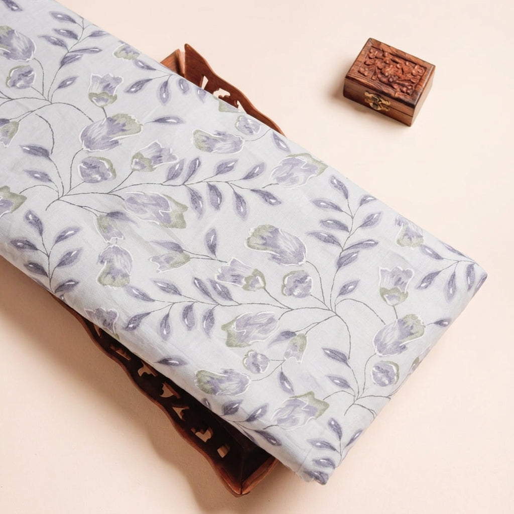 FLORAL GREY FLORAL MUL COTTON Fabric on a wooden tray