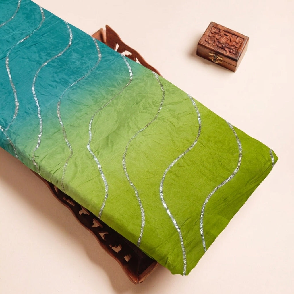Two Toned Green Two Toned Crepe Fabric on a wooden tray