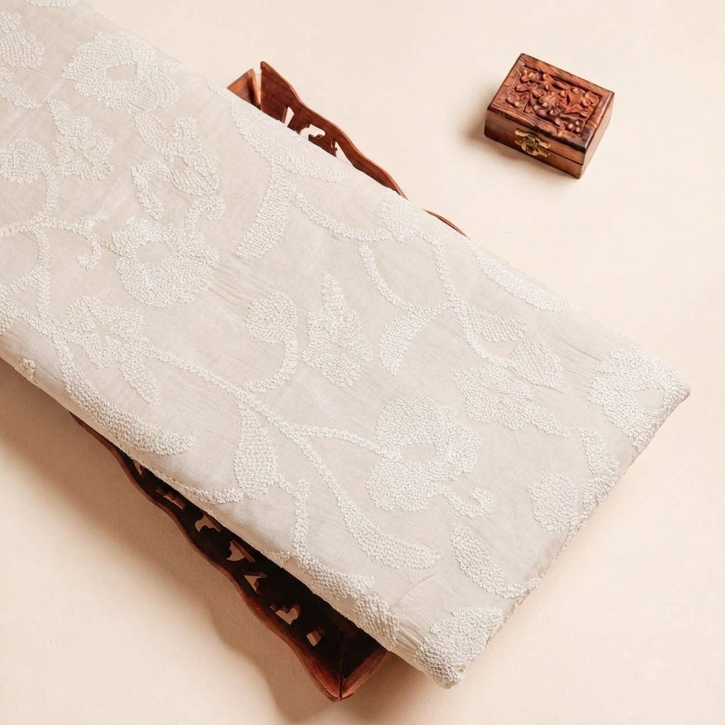 Folded Off White Embroidery Tussar Fabric Highlighting Silk Thread Work Sequin and Texture