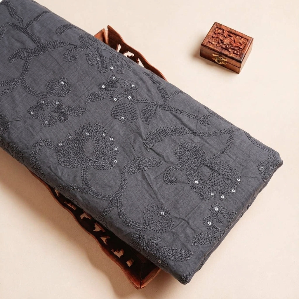 Folded Black Embroidery Tussar Fabric Highlighting Silk Thread Work Sequin and Texture