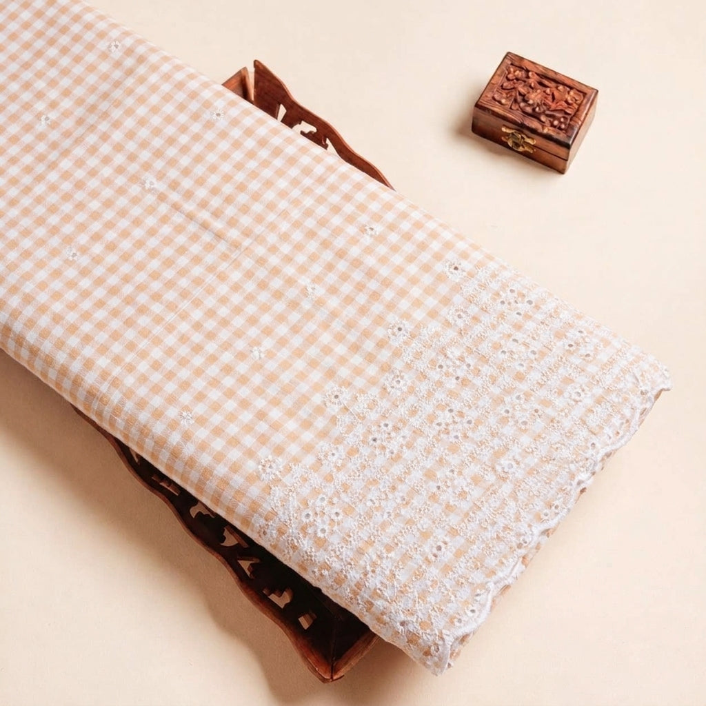 Folded Peach Embroidery Cotton Fabric Highlighting Checked Thread Work Border and Texture