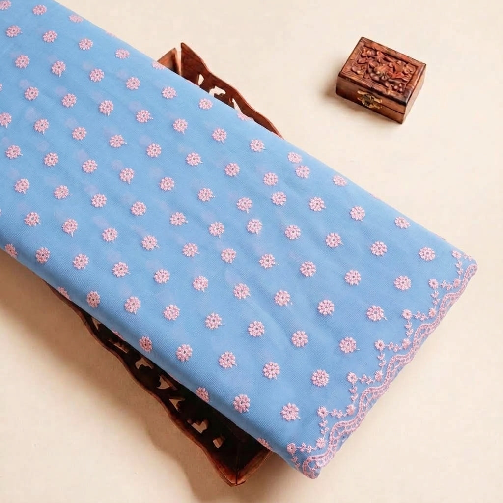 Folded Light Blue Embroidery Cotton Fabric Highlighting Floral Thread Work Border and Texture