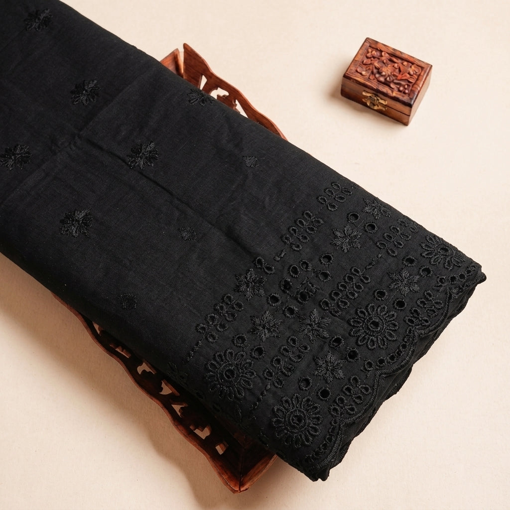 Folded Black Embroidery Cotton Fabric Highlighting Floral Thread Work and Texture