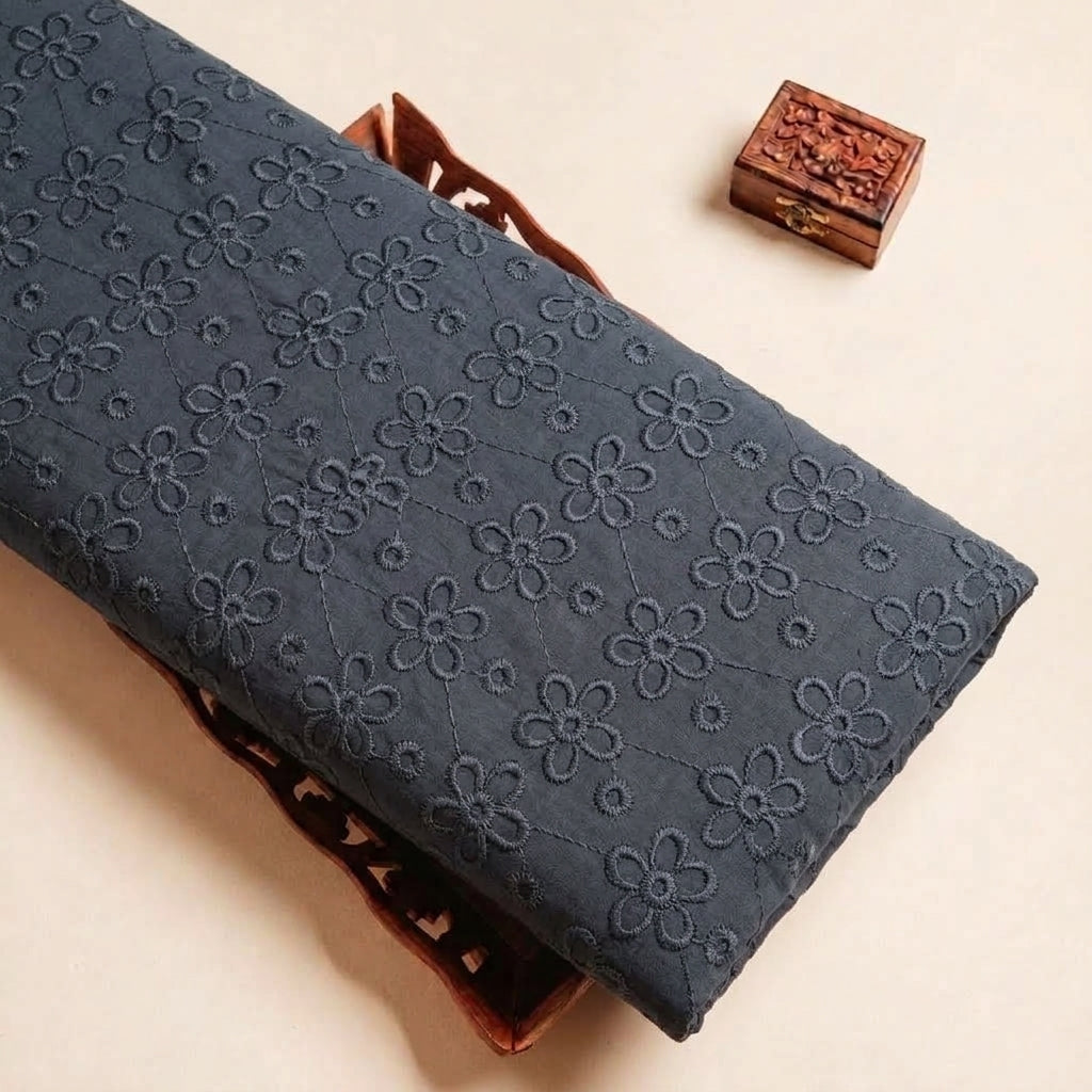 Folded Black Embroidery Cotton Fabric Highlighting Floral Thread Work and Texture