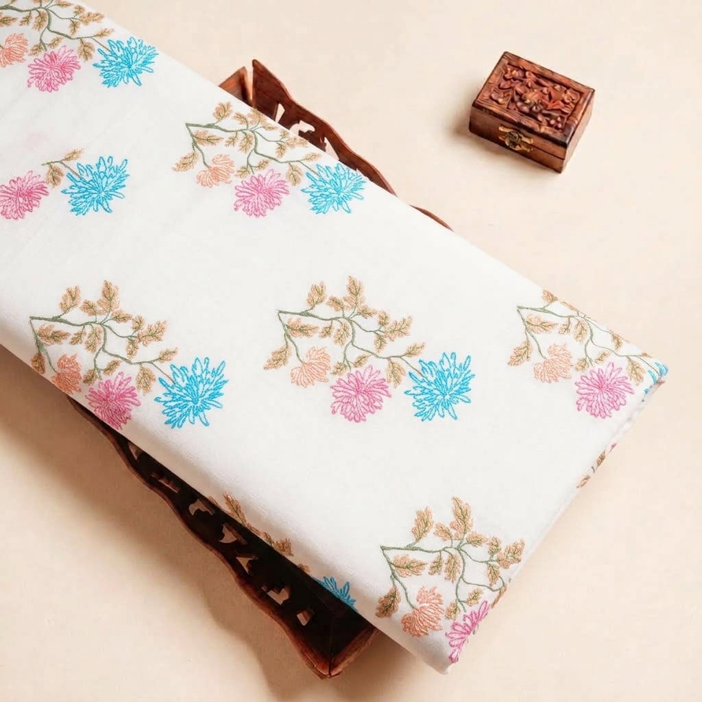 Folded White Embroidery Cotton Fabric Highlighting Floral Thread Work and Texture