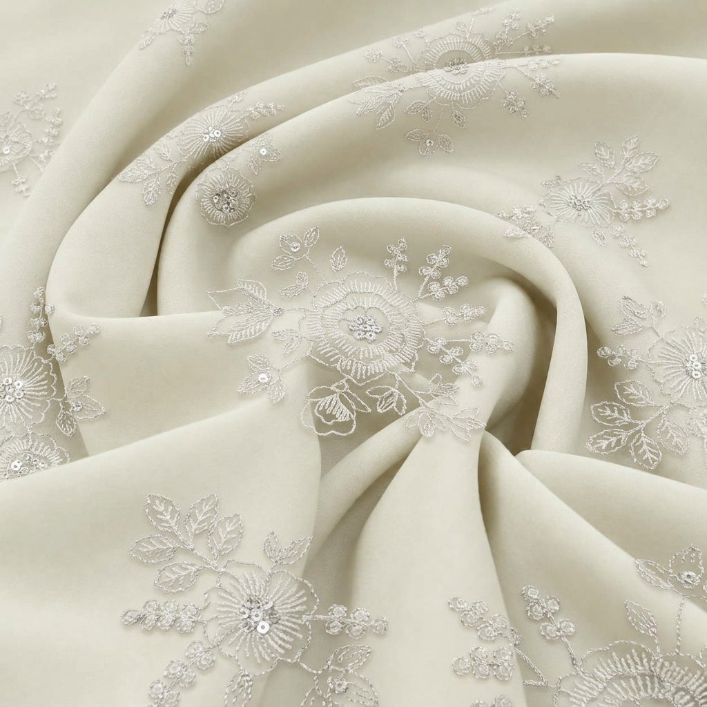 Beige Embroidery Tissue Fabric, swirled to show the drape