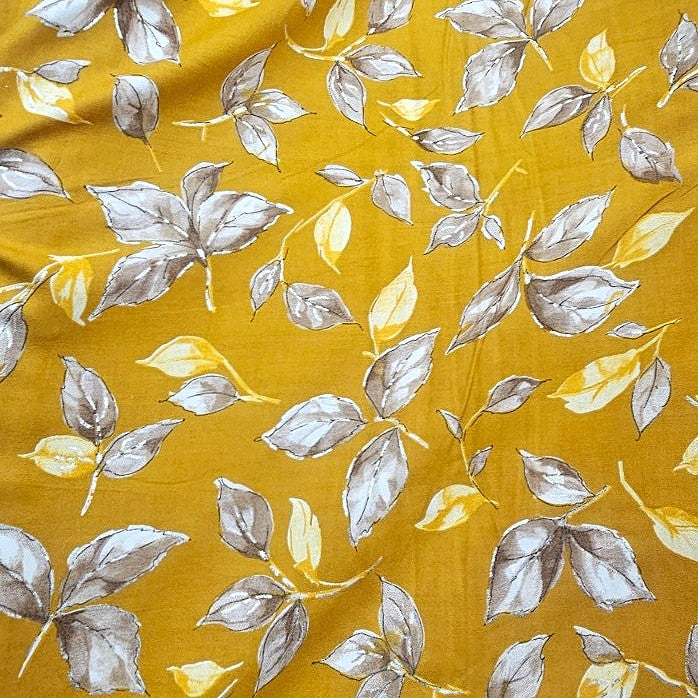 Yellow Foil Print Rayon Fabric, laid flat