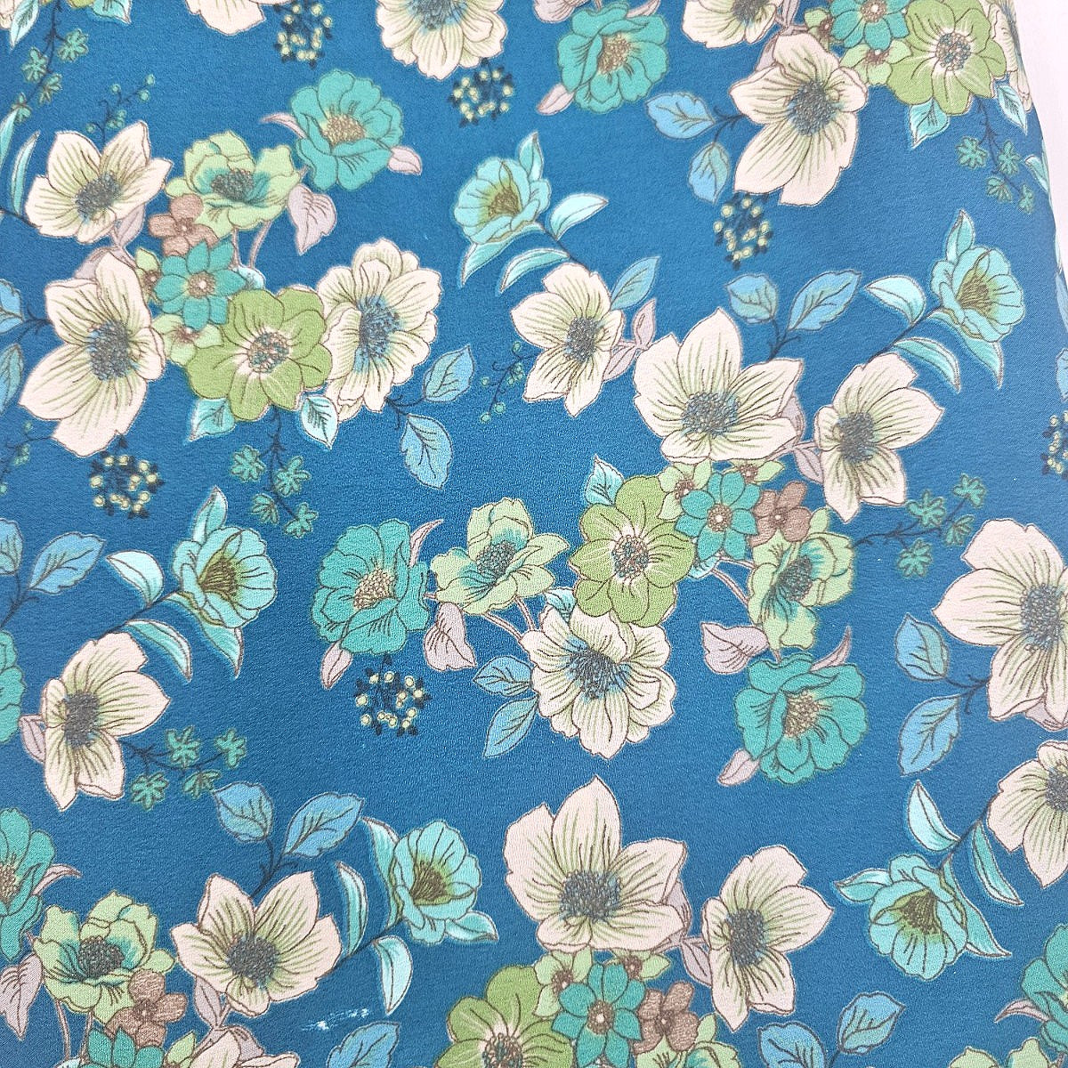 Blue Floral Crepe Fabric, laid flat