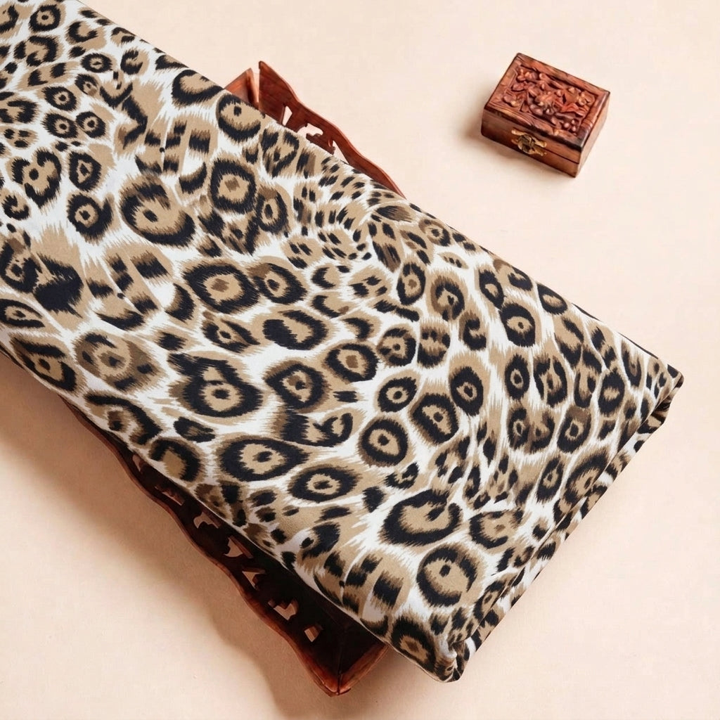 Folded Cream Animal Print Crepe Fabric Highlighting Texture