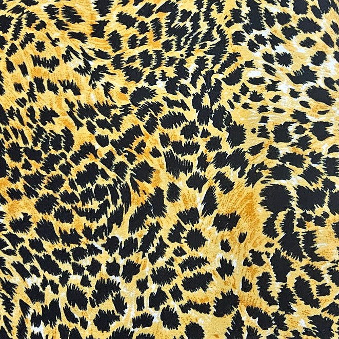 Yellow Animal Print Crepe Fabric, laid flat