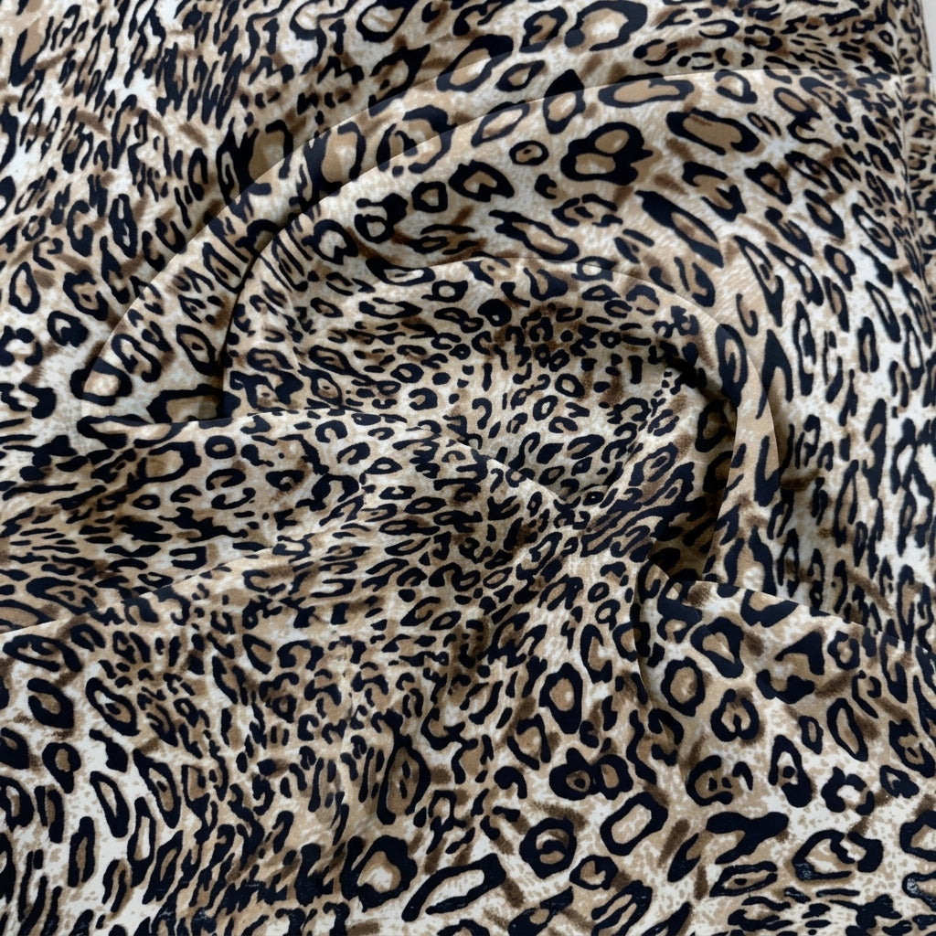 Grey Animal Print Crepe Fabric, swirled to show the drape