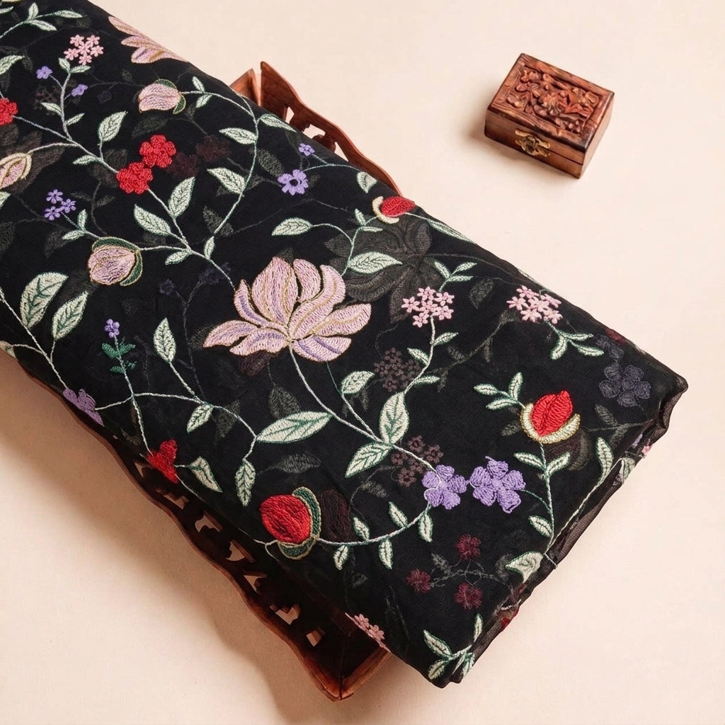 Folded Black Embroidery Georgette Fabric Highlighting Floral and Texture