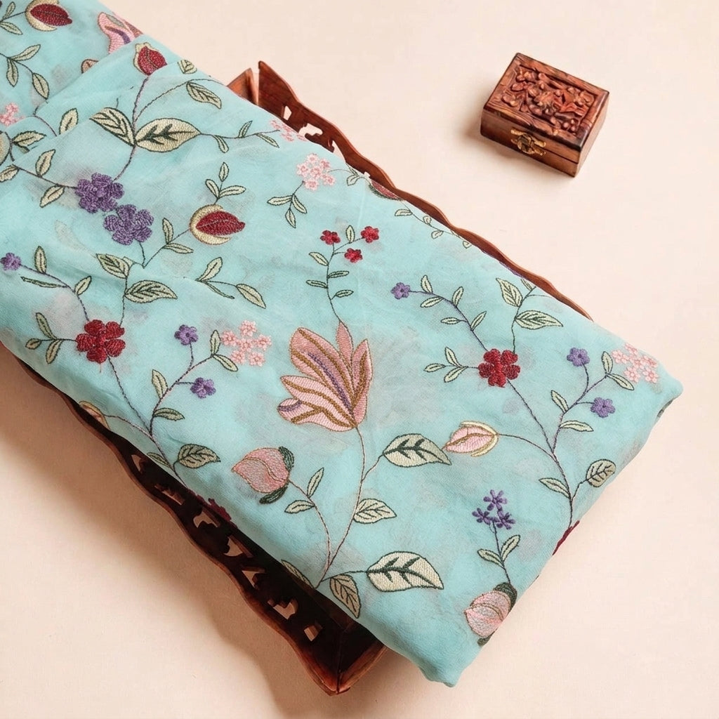Folded Sky Blue Embroidery Georgette Fabric Highlighting Floral and Texture