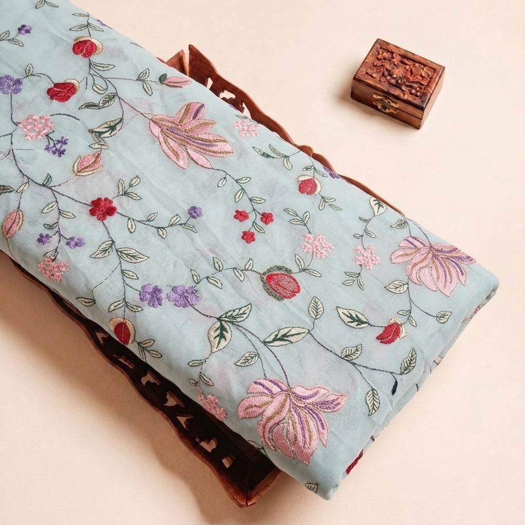 Folded Sky Blue Embroidery Georgette Fabric Highlighting Floral and Texture