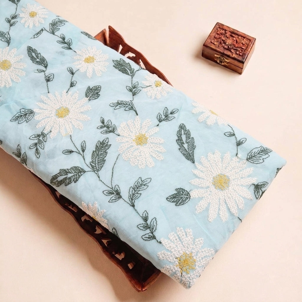 Folded Blue Embroidery Georgette Fabric Highlighting Floral and Texture