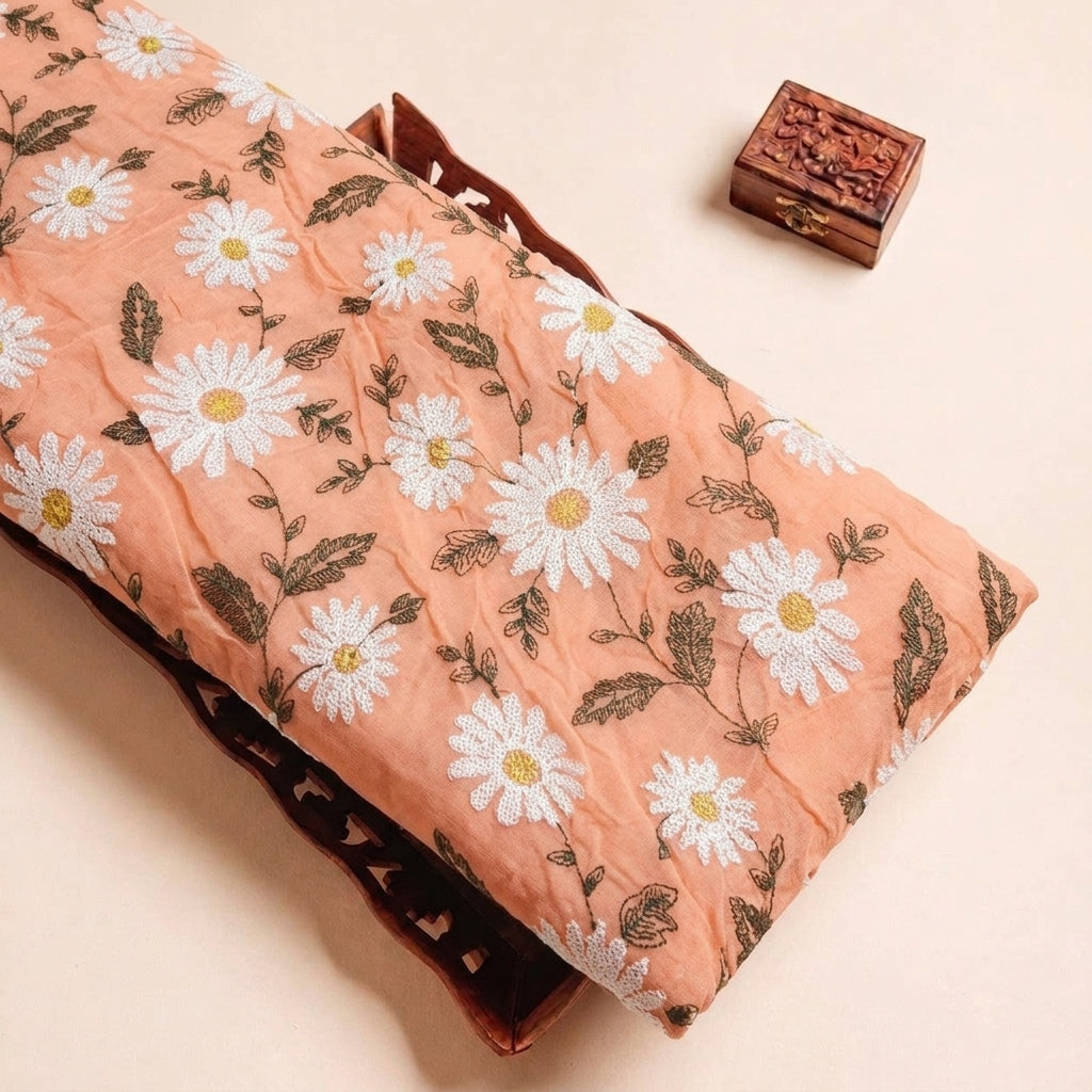Folded Peach Embroidery Georgette Fabric Highlighting Floral and Texture