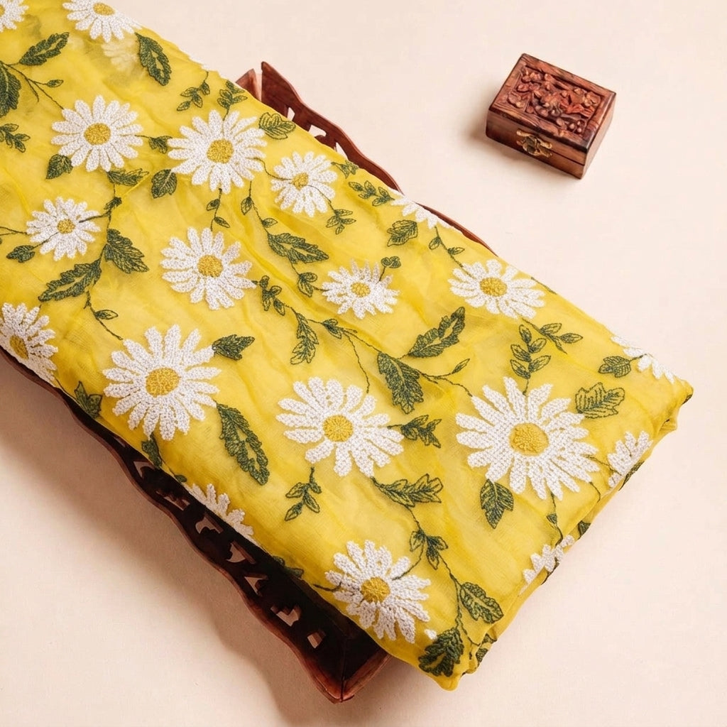 Folded Yellow Embroidery Georgette Fabric Highlighting Floral and Texture