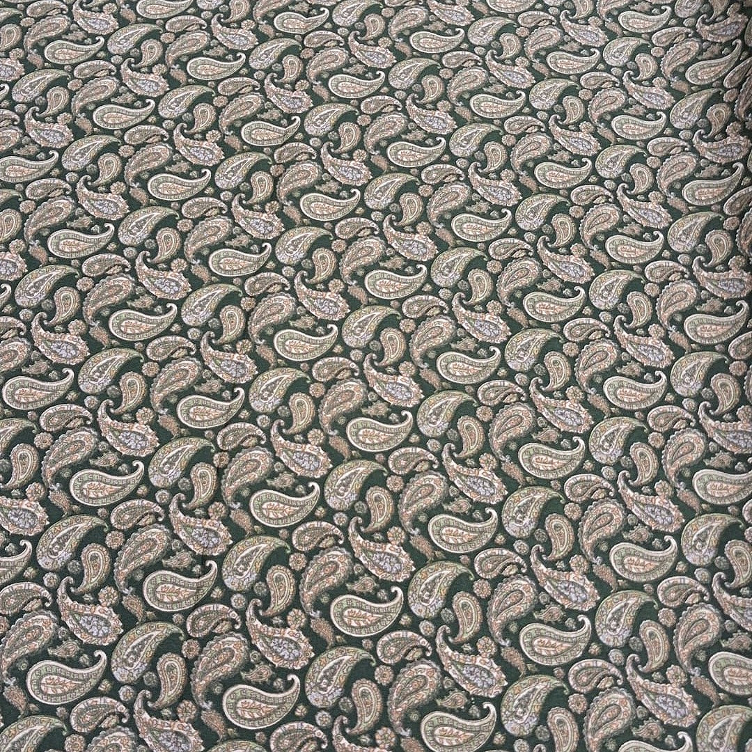 Green Paisley Crepe Fabric, laid flat