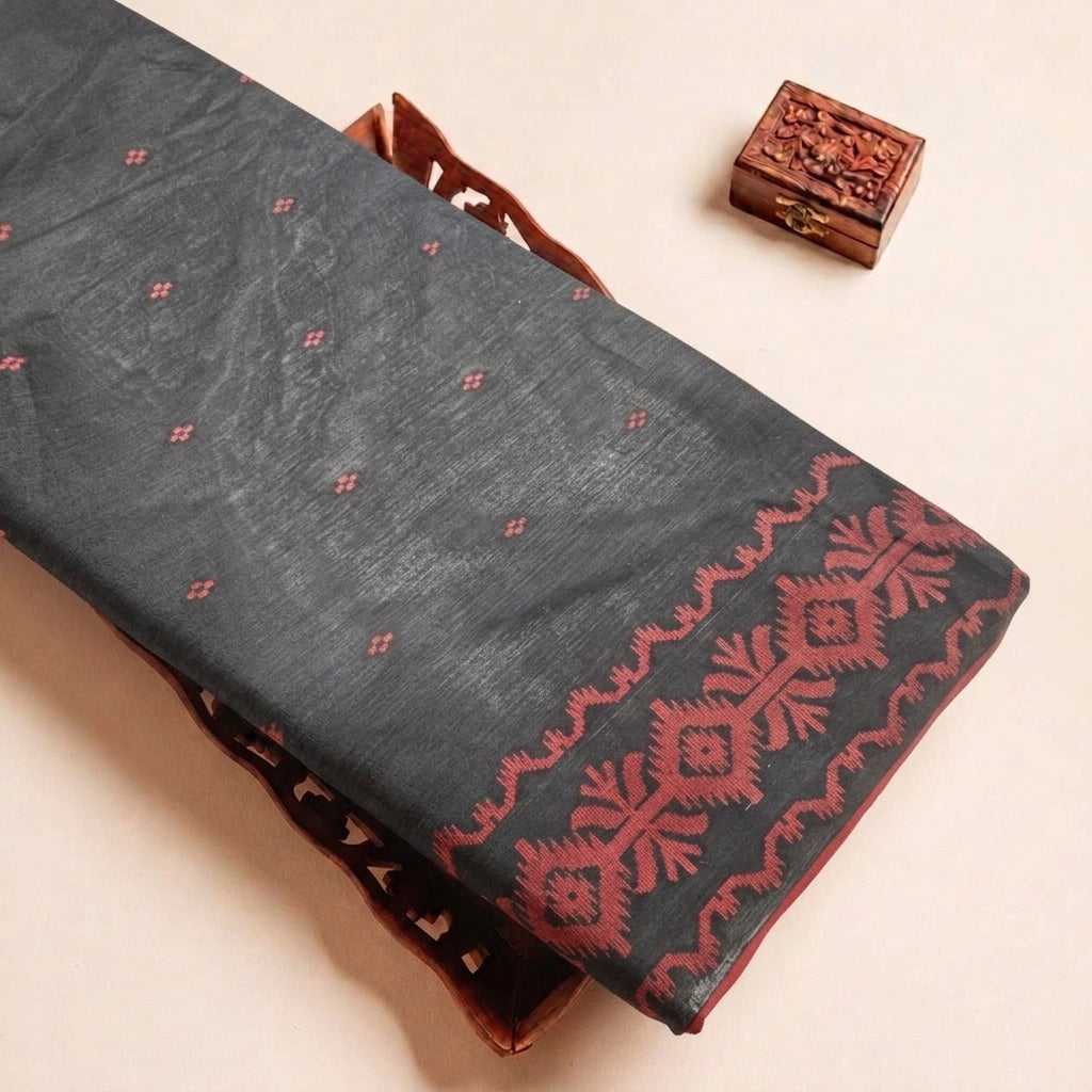 Folded Black Ikat Cotton Fabric Highlighting Border and Texture