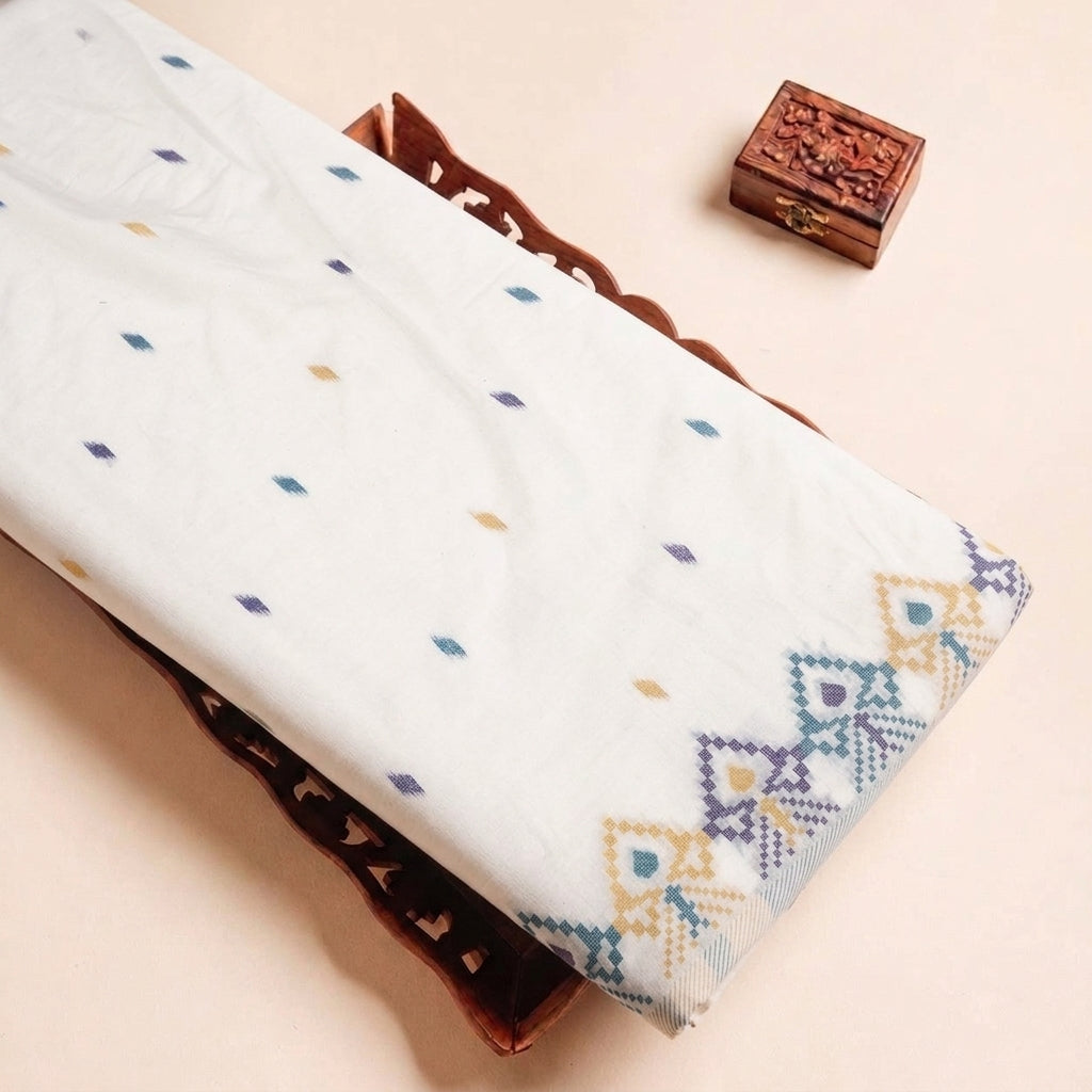 Folded White Ikat Cotton Fabric Highlighting Border and Texture