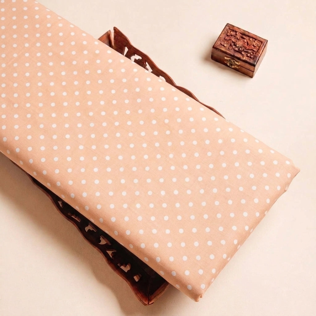Folded Light Peach Polka Dots Cotton Fabric Highlighting Texture