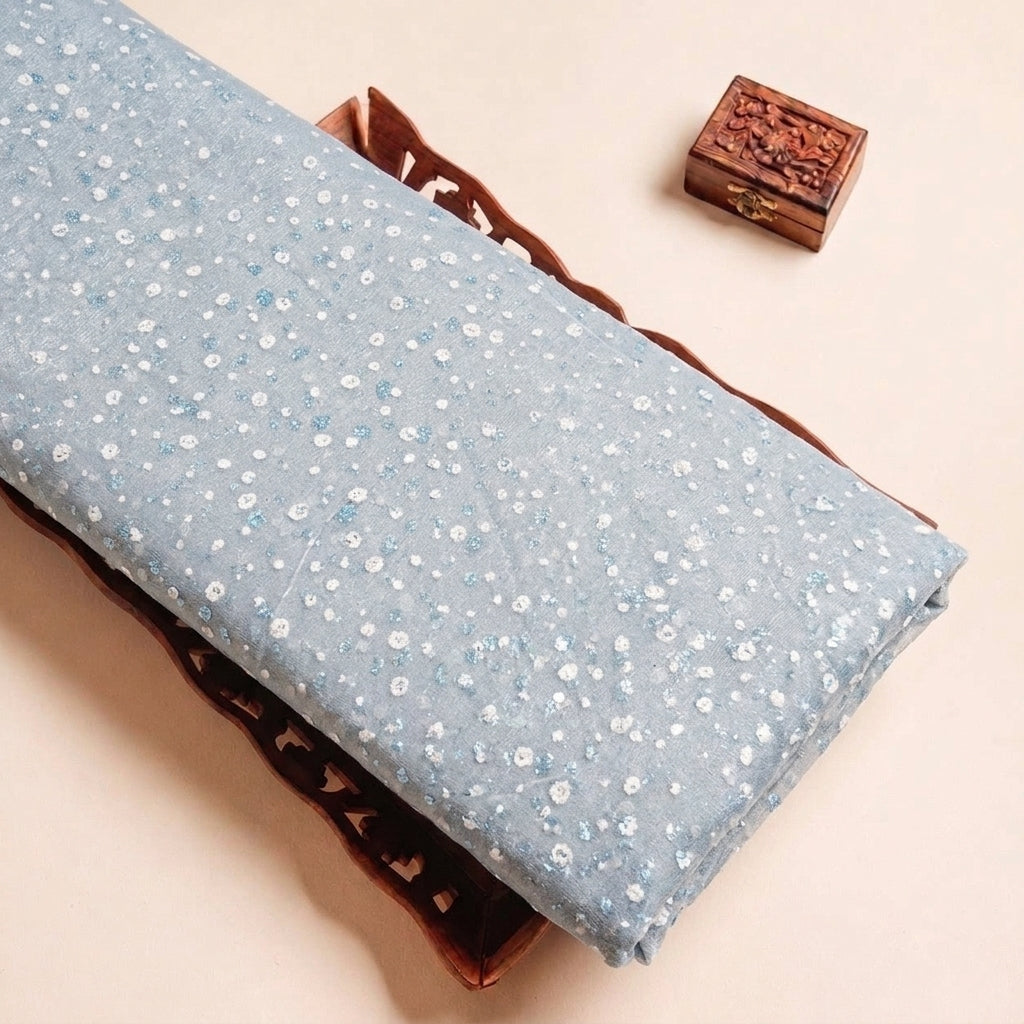 Folded Light Blue Butta Organza Fabric Highlighting Dusted Glitter and Texture