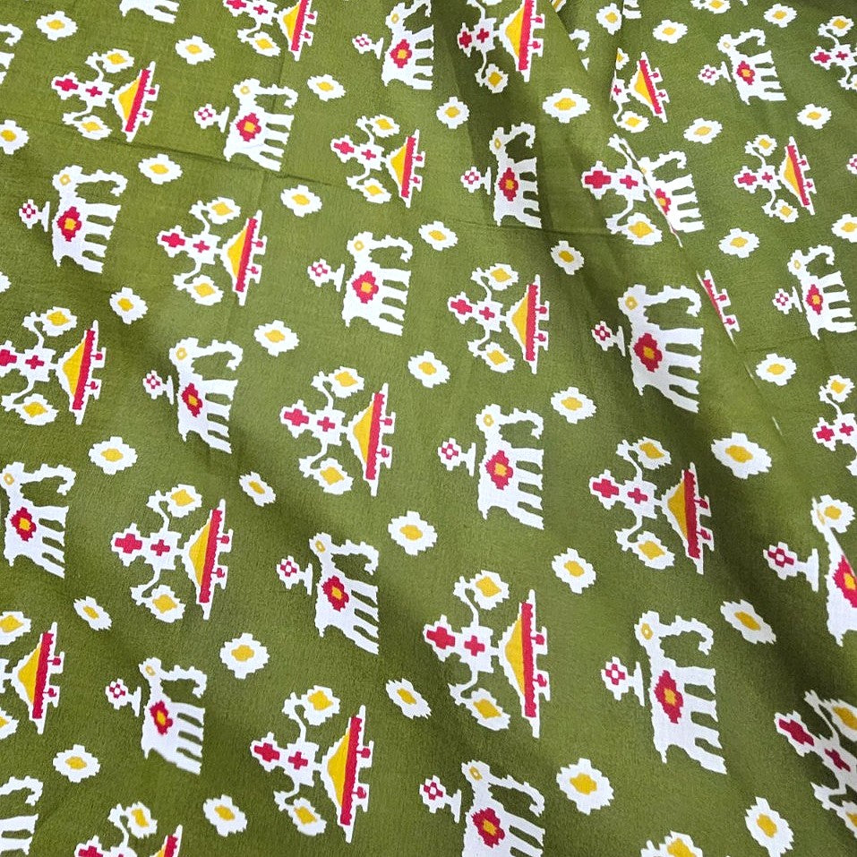 Green Patola Print Cotton Fabric, laid flat