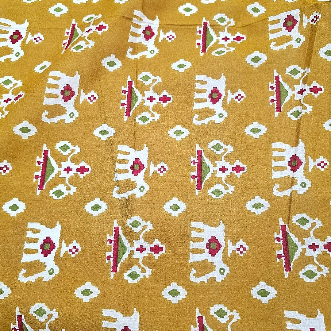Yellow Patola Print Cotton Fabric, laid flat