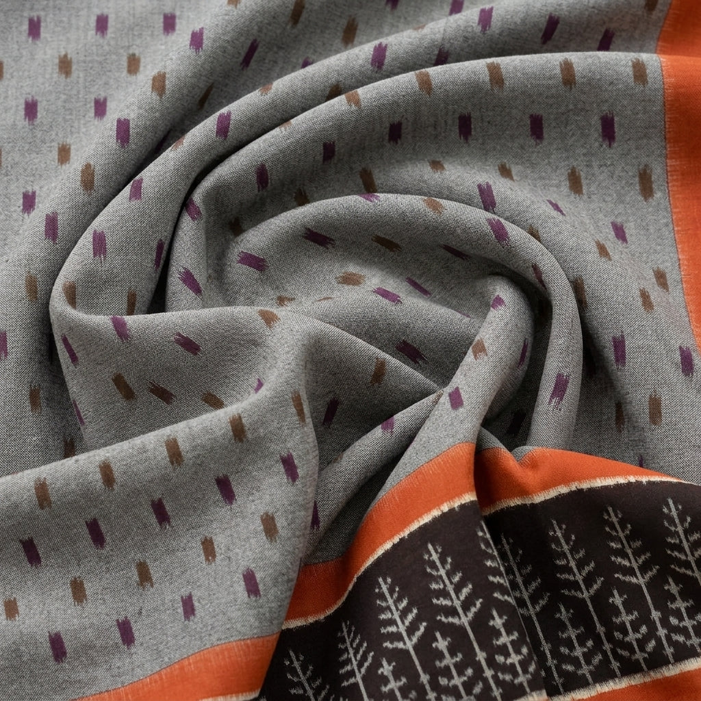 Orangee Ikat Cotton Fabric, swirled to show the drape