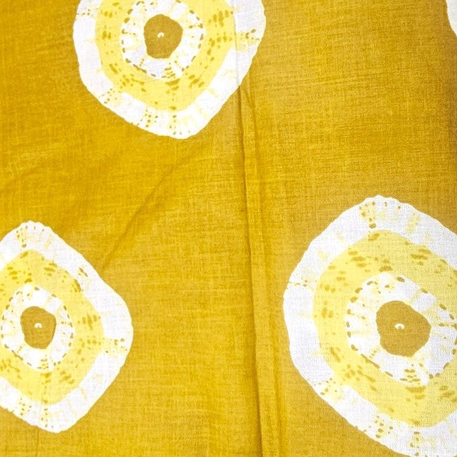 Yellow Bandhini Cotton Fabric, laid flat