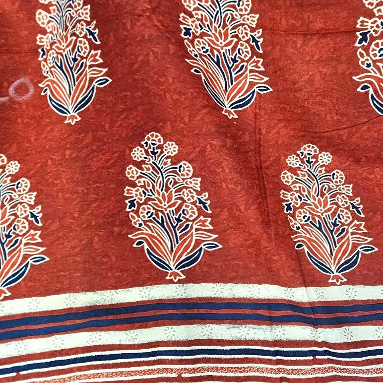 Rust Floral Rayon Fabric, laid flat