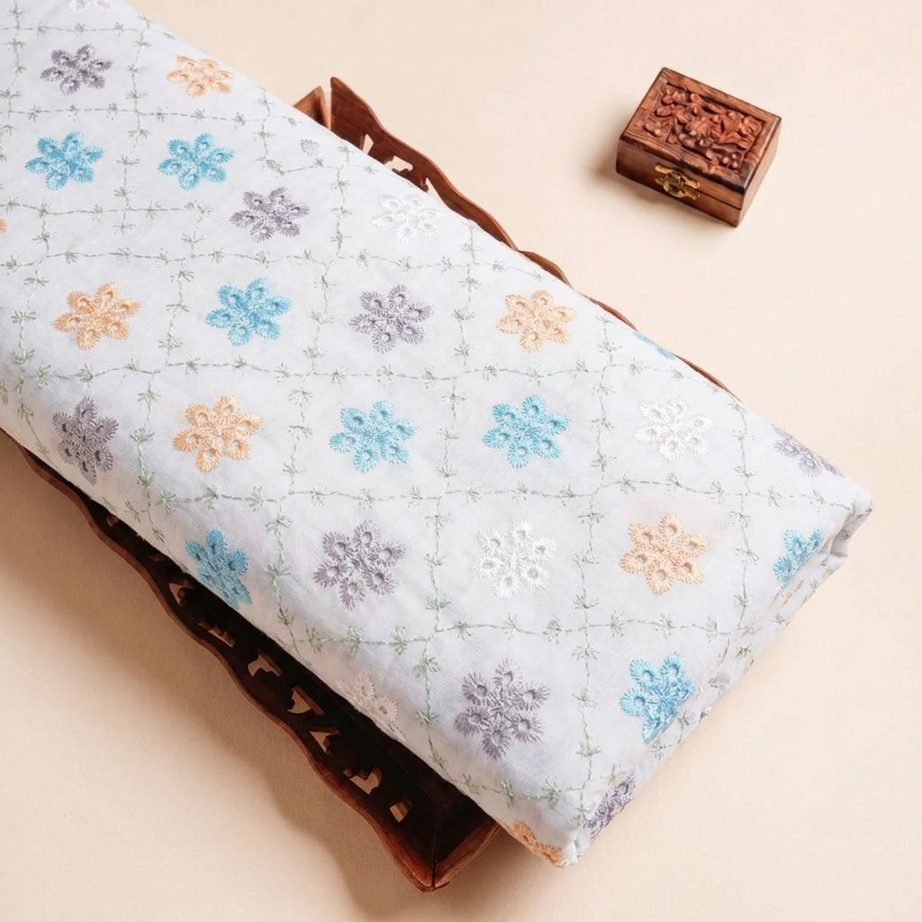 Folded White Embroidery Cotton Fabric Highlighting Floral Thread Work and Texture