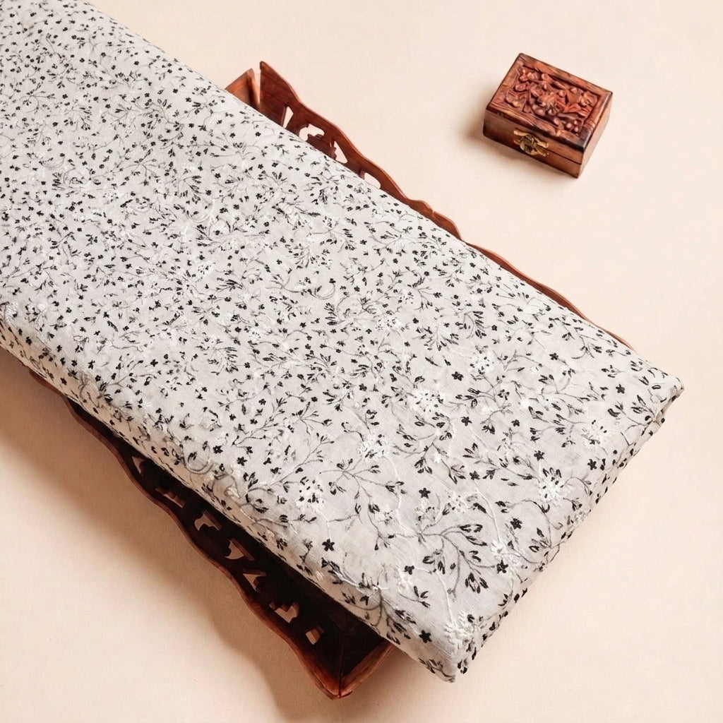 Folded White Embroidery Cotton Fabric Highlighting Floral and Texture