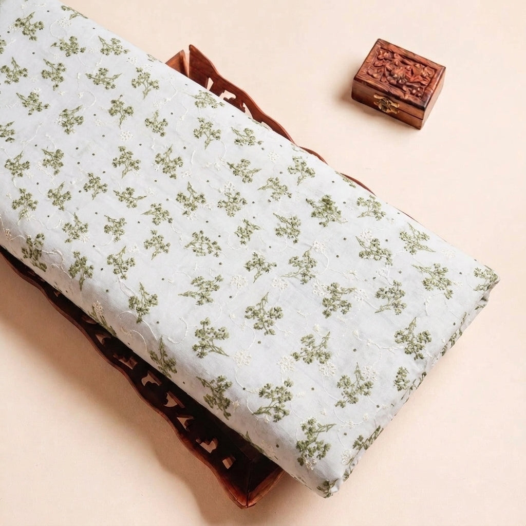 Folded White Embroidery Cotton Fabric Highlighting Floral and Texture