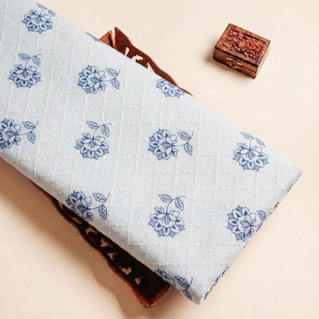Folded Cream Embroidery Cotton Fabric Highlighting Floral Thread Work and Texture