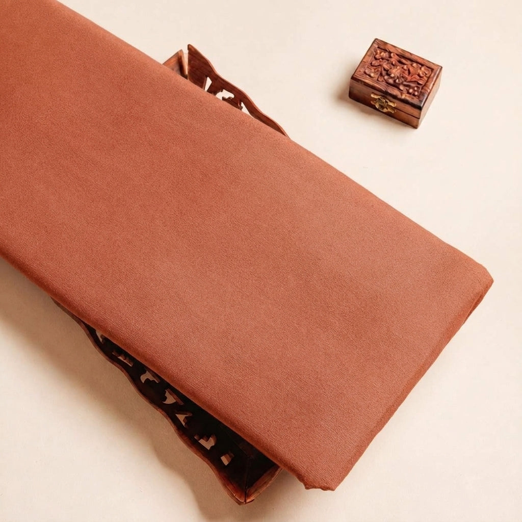 Folded Peach Plain Crepe Fabric Highlighting Lining and Texture