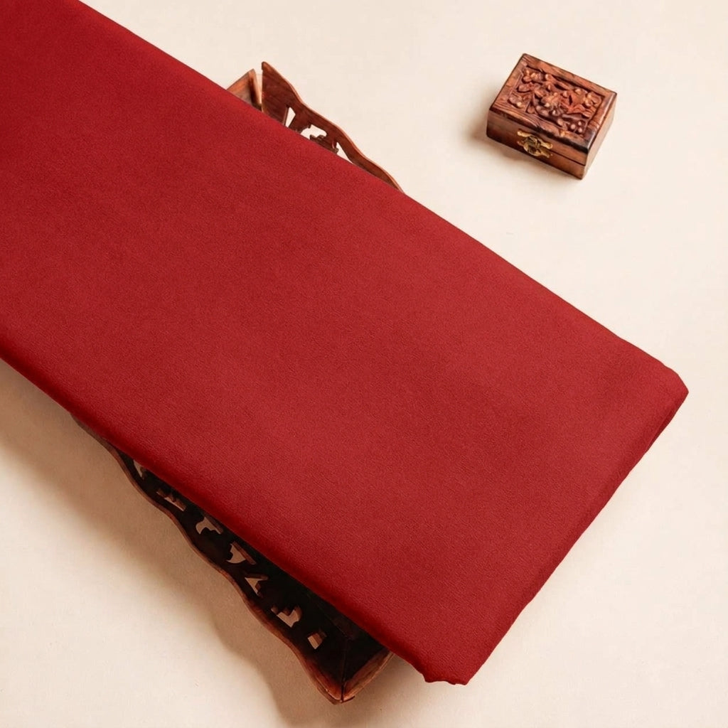 Folded Red Plain Crepe Fabric Highlighting Lining and Texture