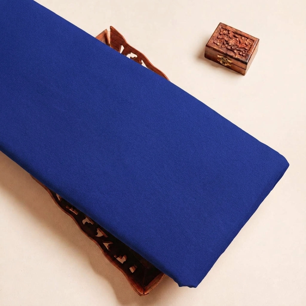 Folded Royal Blue Plain Crepe Fabric Highlighting Lining and Texture