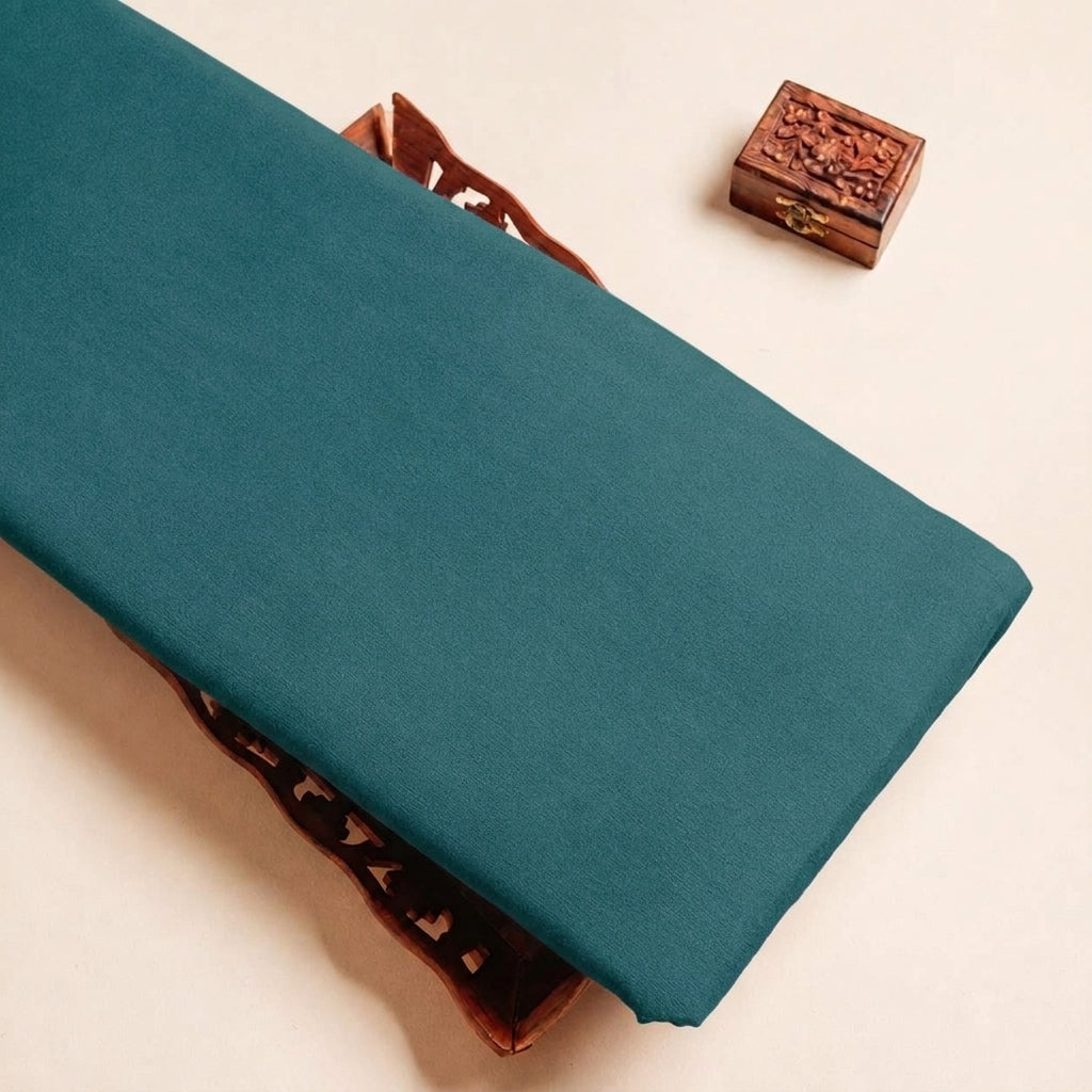 Folded Teal Blue Plain Crepe Fabric Highlighting Lining and Texture